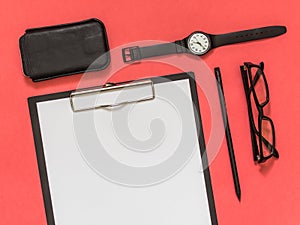 Flat lay black business accessories on pink background with blank space for text. Top view. Copy space.