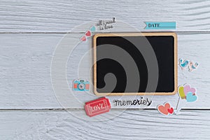 Flat lay black plain wooden tag decorate with stickers on white wooden background
