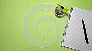 Flat lay black to school and education concept on green background with blank notepad, pencil, green plant and supplies