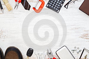 Flat lay of blank space blackboard with blue collar construction tools and white collar& x27;s accessories over wooden background.