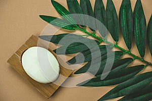 flat lay blank white soap mock up with pal leaf beige background