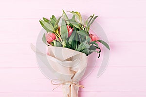 Flat lay bouquet of tulip flowers wrapped in eco brown paper