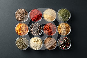 Flat lay. Bowls with different spices on black photo