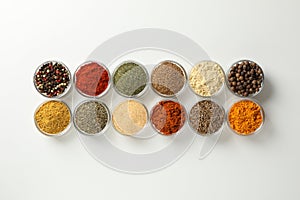 Flat lay. Bowls with different spices on white background