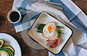 Flat lay breakfast with coffee, avocado, asparagus, egg and bacon