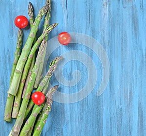 Flat lay with Bunch of fresh green Asparagus and fresh red cherry tomatoes