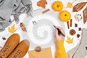 Flat lay with calendar for november with woman fashion fall accessories