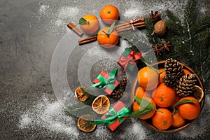 Flat lay Christmas composition with fresh tangerines and gifts on grey background, flat lay. Space for text