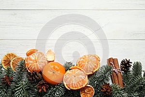 Flat lay Christmas composition with fresh tangerines on white wooden table. Space for text