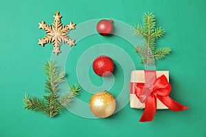 Christmas composition with gift box and festive decor on color background