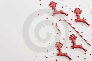 Flat lay of Christmas red deer and stars border frame on white background copy space. Christmas composition for your creative