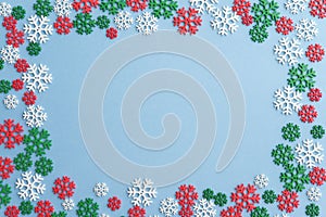 Flat lay of Christmas snowflake border frame on blue background with copy space. Christmas composition for your creative design