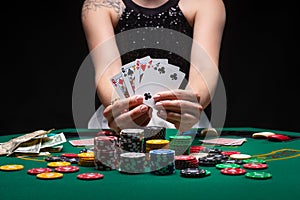 Flat lay Close-up cards for playing poker on a gaming table in a casino against a background of chips. Background for a gaming