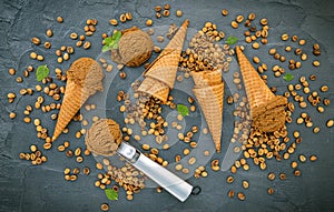 Flat lay coffee ice cream in waffle cone on dark stone background . Homemade coffee ice cream  with coffee beans for sweets menu