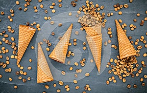 Flat lay coffee ice cream in waffle cone on dark stone background . Homemade coffee ice cream  with coffee beans for sweets menu