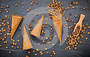 Flat lay coffee ice cream in waffle cone on dark stone background . Homemade coffee ice cream  with coffee beans for sweets menu