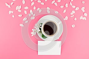 Flat lay of coffee, letter mockup and white petals