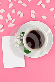 Flat lay of coffee, letter mockup and white petals