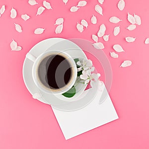 Flat lay of coffee, letter mockup and white petals