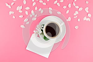 Flat lay of coffee, letter mockup and white petals