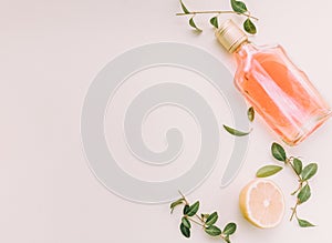 Flat lay of cold refreshing summer alcohol cocktail with fresh lemon , orange mint and ice bottle over white marble background, fl