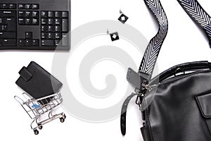 Flat lay collage of keyboard, womenâ€™s bag, cardholder in shopping cart isolated on white background. Buy online on internet