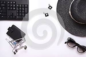 Flat lay collage of keyboard, womenâ€™s hat, cardholder in shopping cart isolated on white background. Buy online on internet