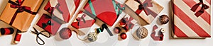 Flat-lay color craft gift boxes and Christmas decorations, wide composition