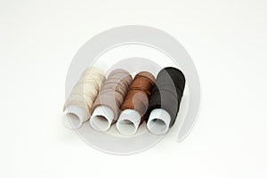 Flat lay colorful cotton thread spools, embroidery yarn, white, brown, black, bobbins, mock up, top view. Layout mockup, blank