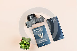 Flat lay of compact camera with Thailand official passport