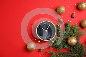 Flat lay composition with alarm clock, fir branches and decorations on color background. Christmas countdown