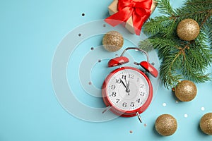 Composition with alarm clock, gift box and beautiful decorations on color background. Christmas countdown