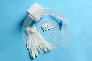 Flat lay composition with anoscope on light blue background. Hemorrhoid treatment