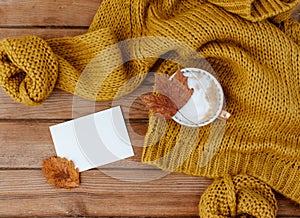 Flat lay composition with autumn leaves, hot coffee, warm sweater