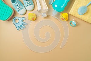 Flat lay composition with baby bath and children health care products on modern background. Infant shampoo, duck toys and towel.