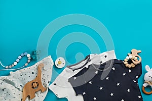 Flat lay composition with baby clothes and accessories on light blue, space for text