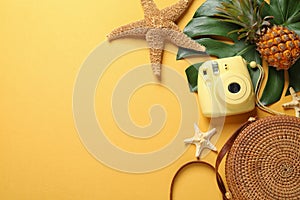 Flat lay composition with bag and camera, space for text. Beach accessories
