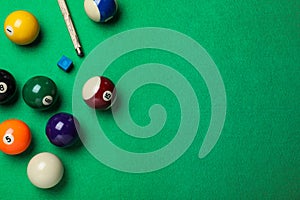 Flat lay composition with balls on billiard table, space for text