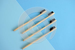 Flat lay composition with bamboo toothbrushes on lightblue and blue background