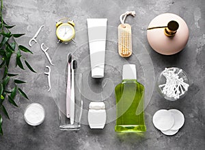 Flat lay composition of bath accessories and cosmetics on gray background
