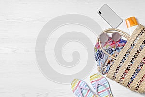 Flat lay composition with beach  and accessories on white wooden background, space for text