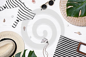 Flat lay composition with beach bag and accessories on wooden background