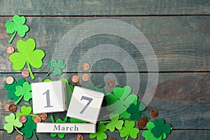 Flat lay composition with block calendar on wooden background, space for text. St. Patrick`s Day celebration