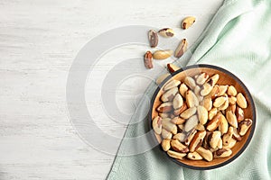 Flat lay composition with Brazil nuts on white wooden background