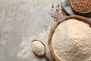 Flat lay composition with buckwheat flour on table, space for text