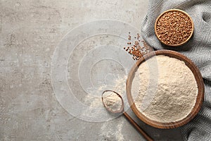 Flat lay composition with buckwheat flour on table, space for text