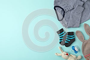 Flat lay composition with child`s clothes and accessories on blue background, space for text