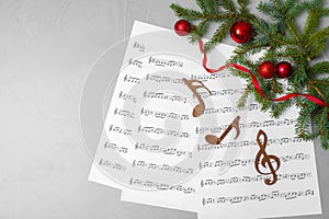 Flat lay composition with Christmas decor, music sheets, wooden notes and space for text