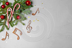 Flat lay composition with Christmas decor, wooden music notes and space for text