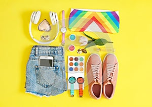 Flat lay composition with clothes and accessories on color background.